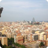 The towers of Sagrada Familia provide an expansive view of the Mediterranean city of Barcelona. The Agbar Tower, a skyscraper 144 meters tall can be noted in the cityscape profile.  It's shape inspired by the eruptions of a geyser, Gaudian architecture and Montserrat Mountain.