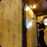 Heather at Work; Faux Finished Walls with Stenciled Allover Ornamental Damask Effect.